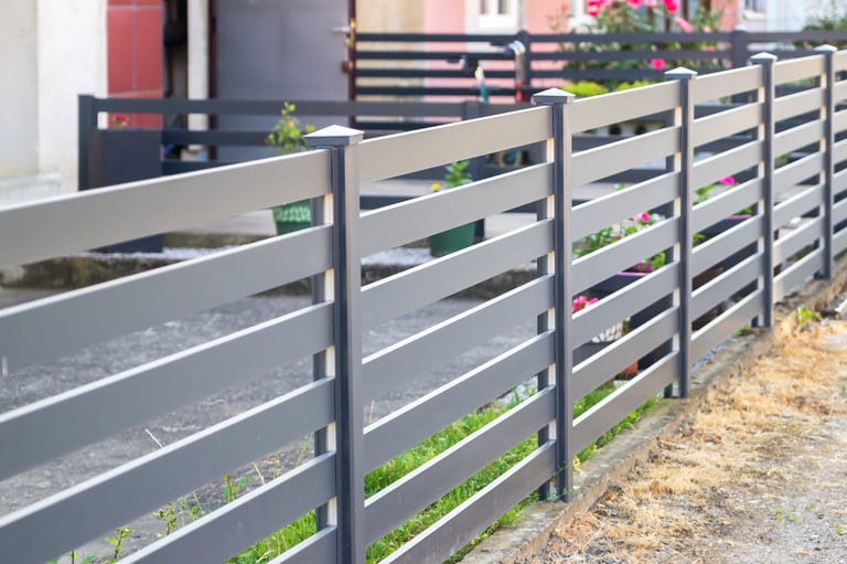 Modern stone fence with aluminum or metal shutter
